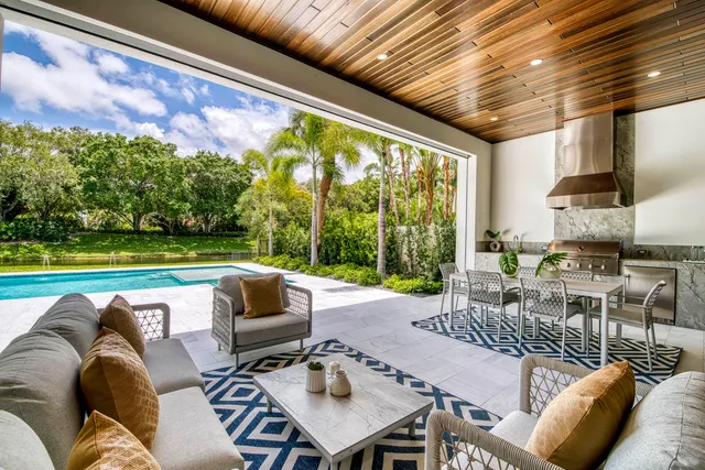 a view of house with swimming pool and outdoor seating