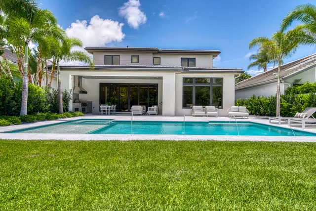 a bedroom with a bed a large window with outer view and couch
