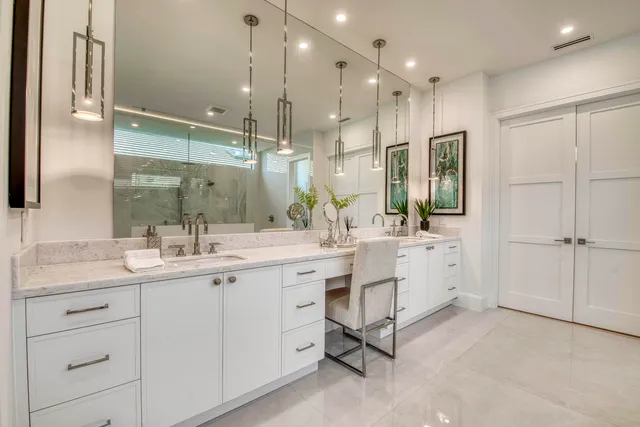 a bathroom with a double vanity sink mirror and shower