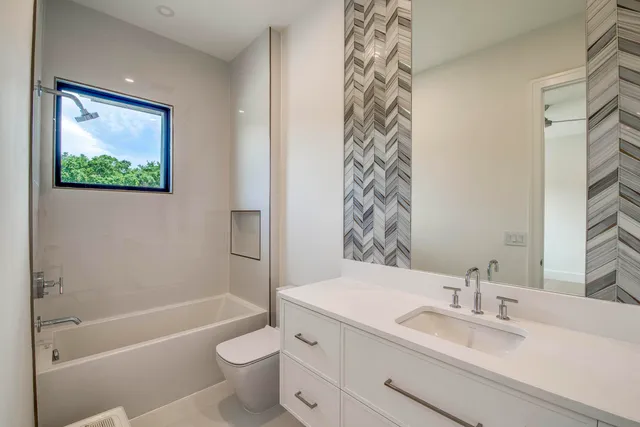 an aerial view of a house with a yard and lake view