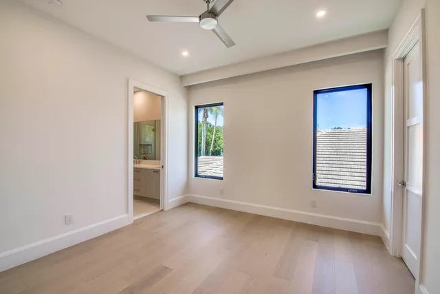 an aerial view of a house with a garden and lake view