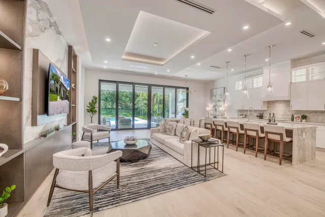 a living room with lots of furniture and a large window