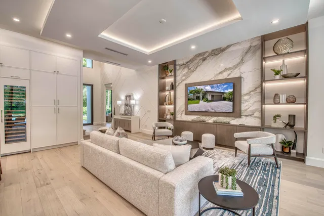 a living room with lots of furniture and view of kitchen