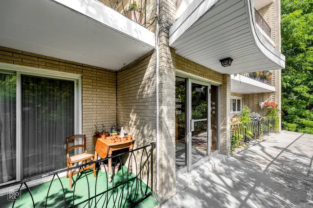 a view of a patio with table and chairs and potted plants