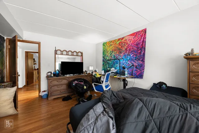 a bed room with two bed and a television