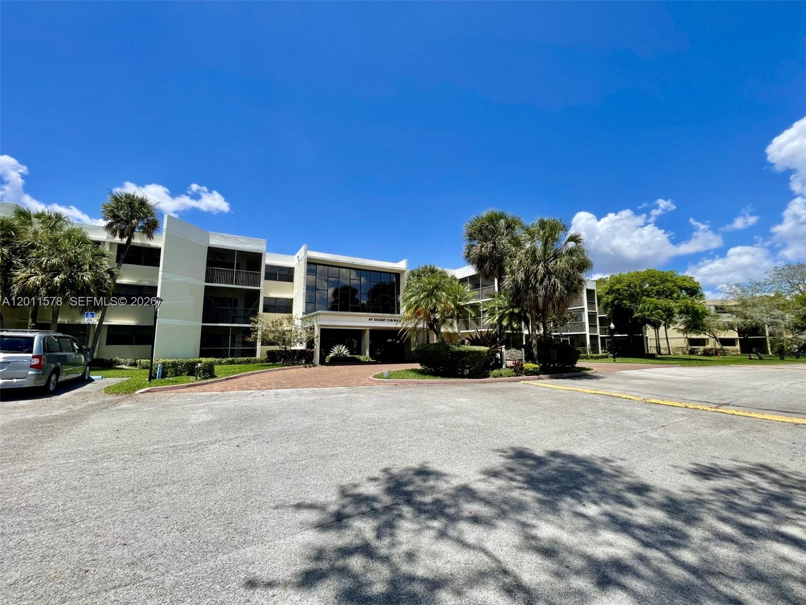 491 Racquet Club Road, Unit 303 Weston, FL 33326 - Photo 38 of 46 a view of a house with a yard and garage