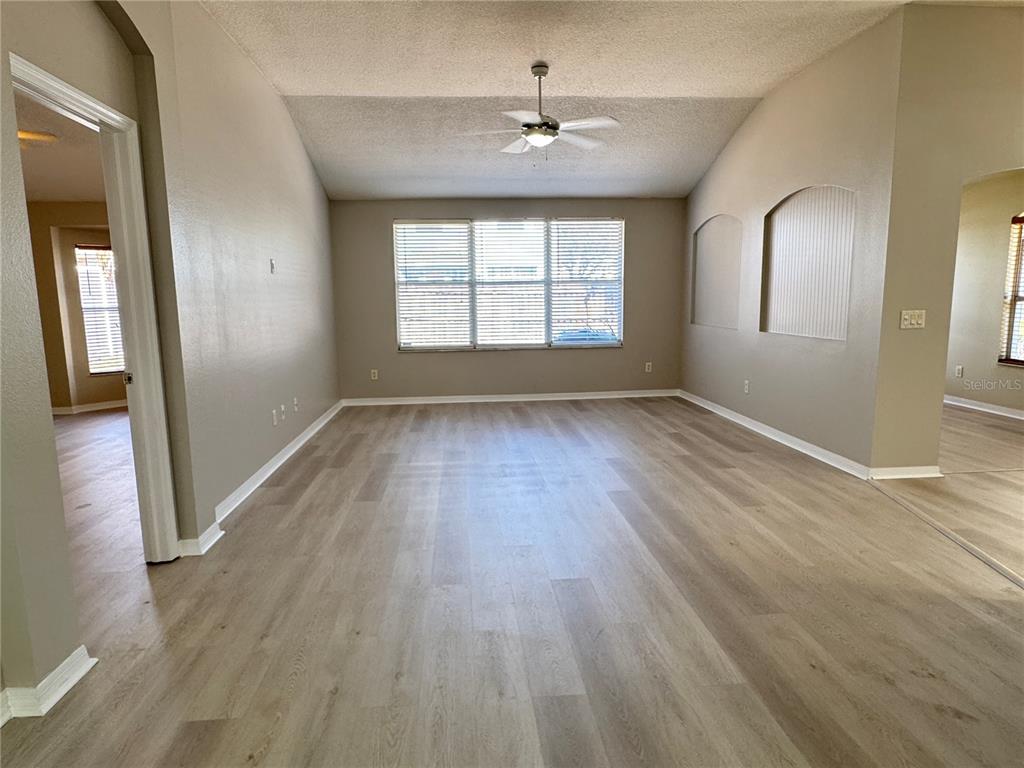 1414 Trail Boss Lane Brandon, FL 33511 - Photo 11 of 37 an empty room with wooden floor and windows