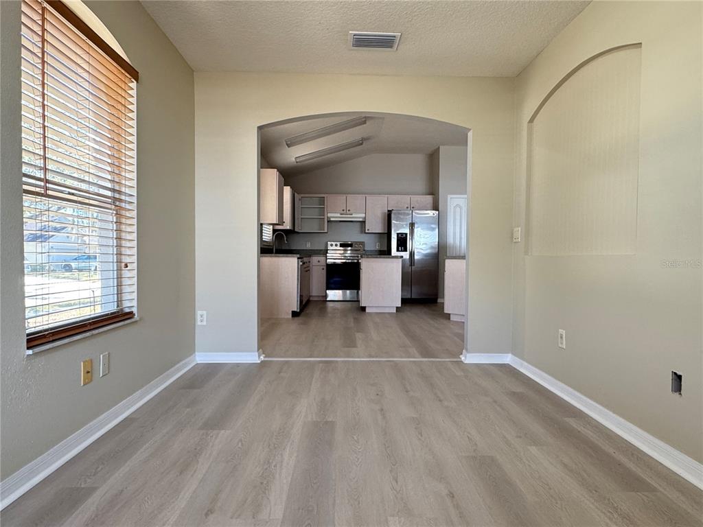 1414 Trail Boss Lane Brandon, FL 33511 - Photo 15 of 37 a view of a room with kitchen island stainless steel appliances wooden floor and window