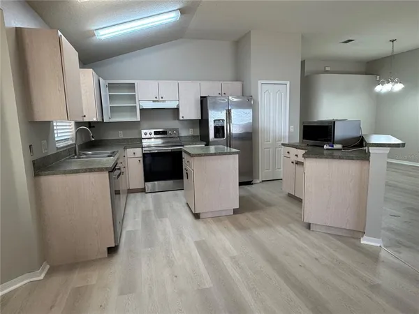 a kitchen with a sink cabinets and stainless steel appliances