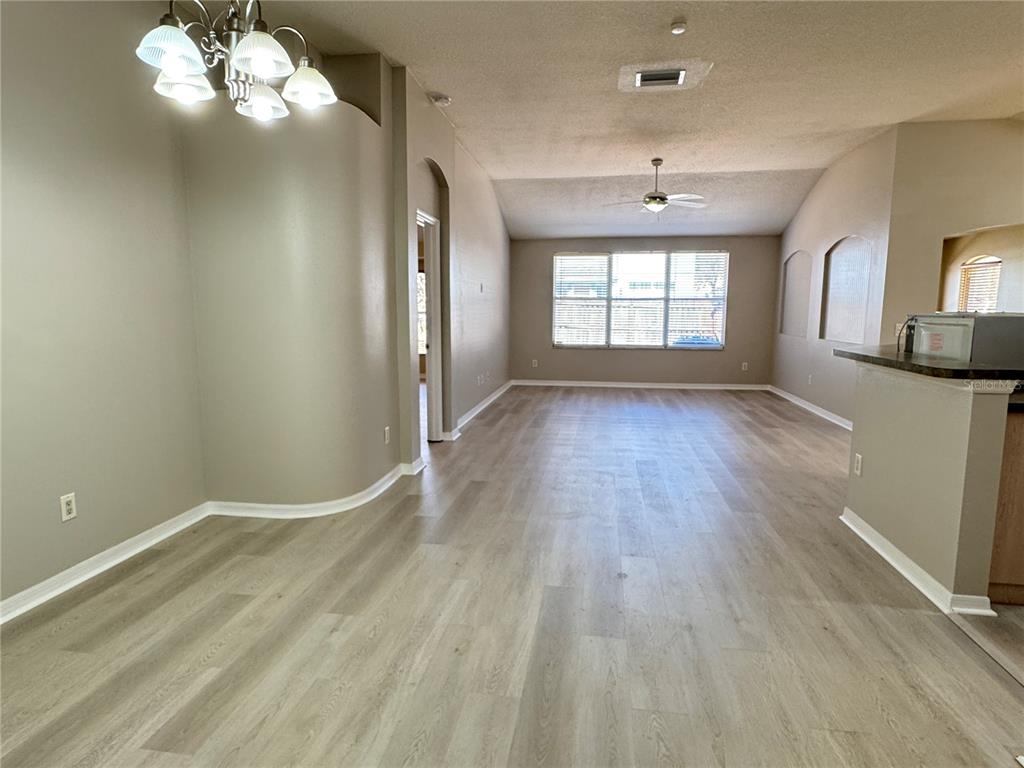 1414 Trail Boss Lane Brandon, FL 33511 - Photo 2 of 37 wooden floor in an empty room with a window