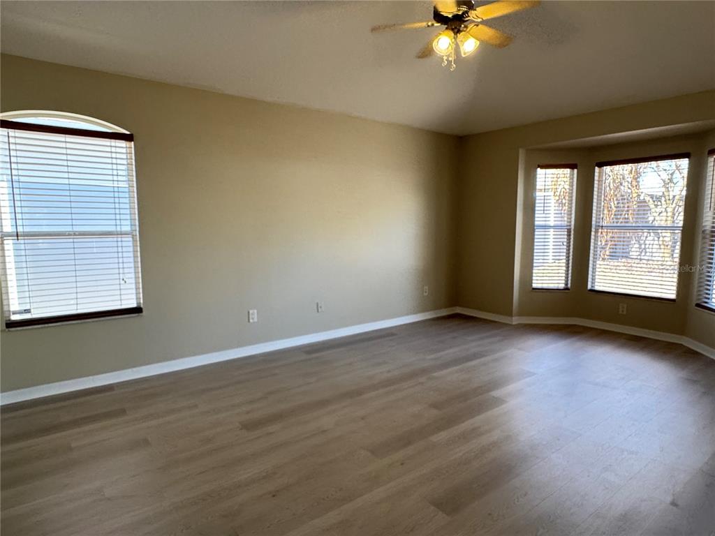 1414 Trail Boss Lane Brandon, FL 33511 - Photo 25 of 37 a view of an empty room with wooden floor and a window