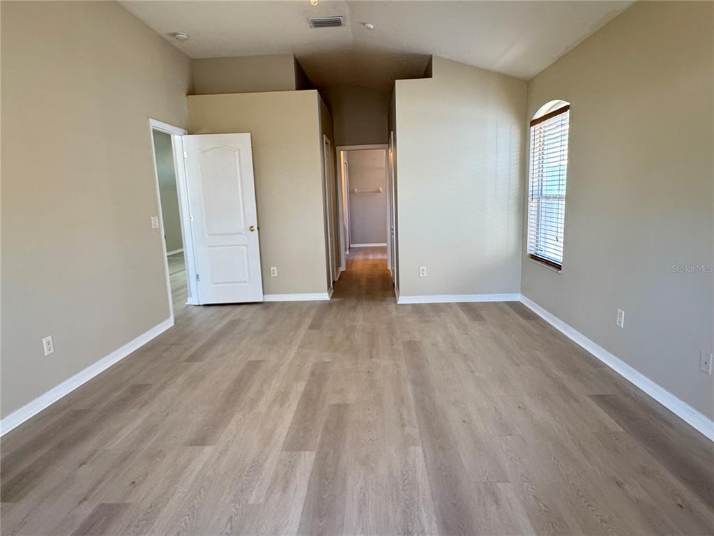 1414 Trail Boss Lane Brandon, FL 33511 - Photo 26 of 37 an empty room with wooden floor and windows
