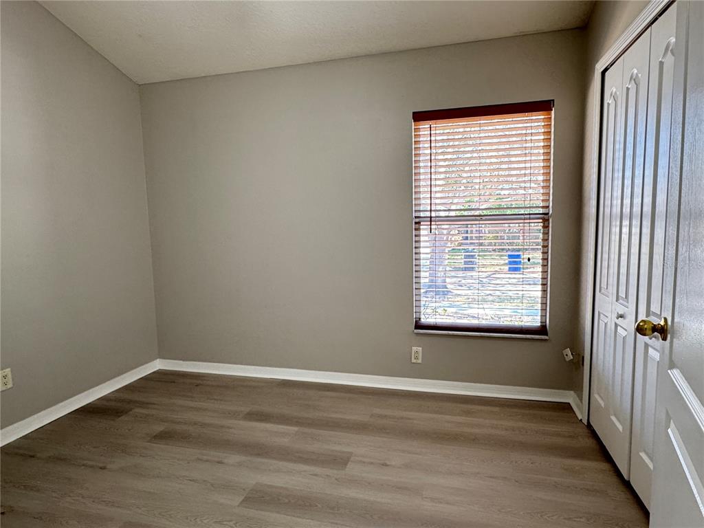 1414 Trail Boss Lane Brandon, FL 33511 - Photo 28 of 37 a view of an empty room with wooden floor and a window
