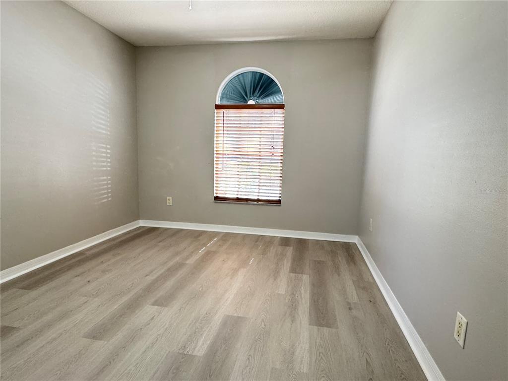1414 Trail Boss Lane Brandon, FL 33511 - Photo 30 of 37 an empty room with a window and wooden floor