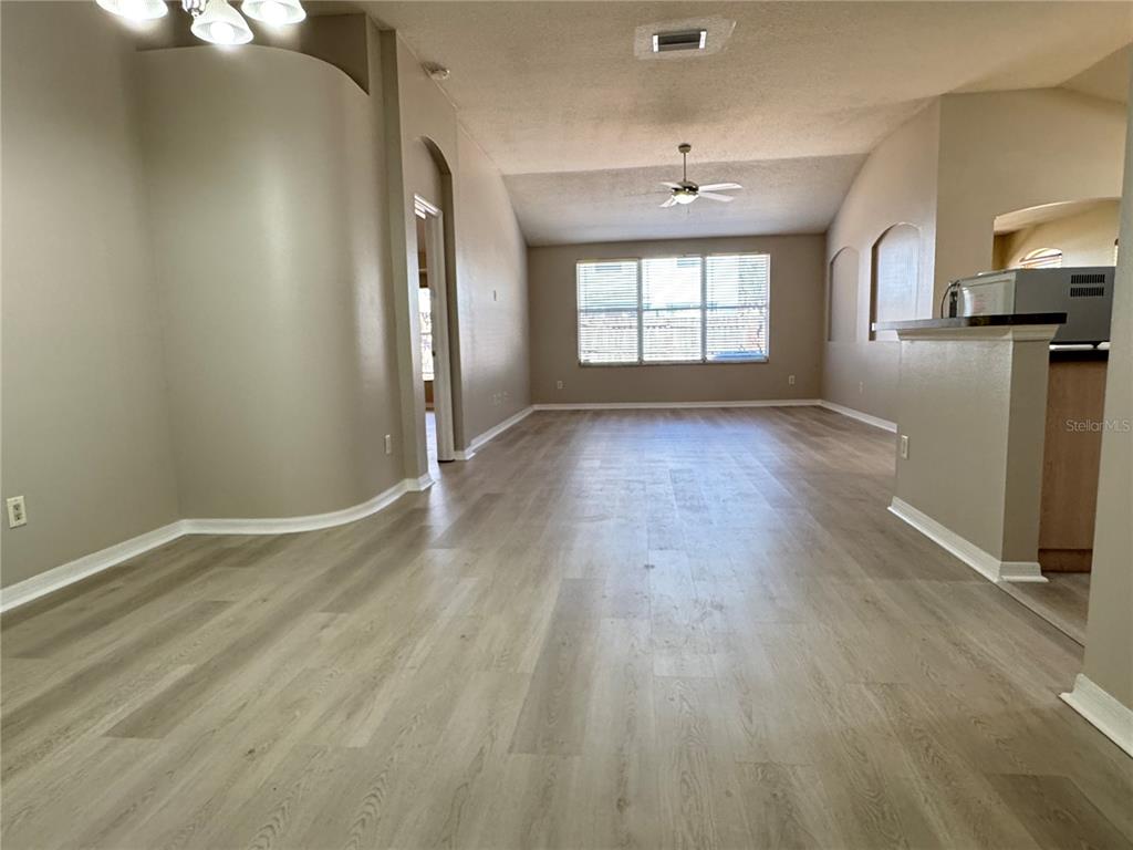 1414 Trail Boss Lane Brandon, FL 33511 - Photo 4 of 37 wooden floor in an empty room with a window
