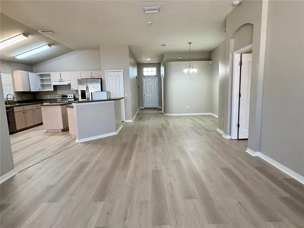 a view of kitchen with sink microwave and refrigerator