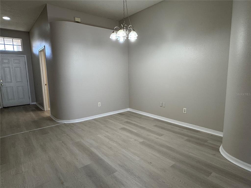 1414 Trail Boss Lane Brandon, FL 33511 - Photo 7 of 37 an empty room with wooden floor and windows