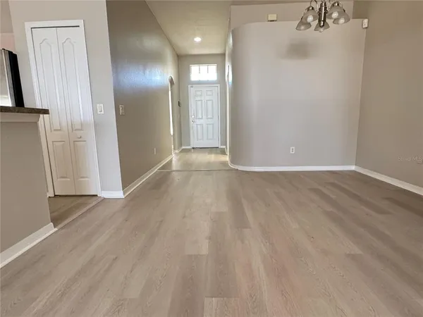 a view of a livingroom with wooden floor and staircase