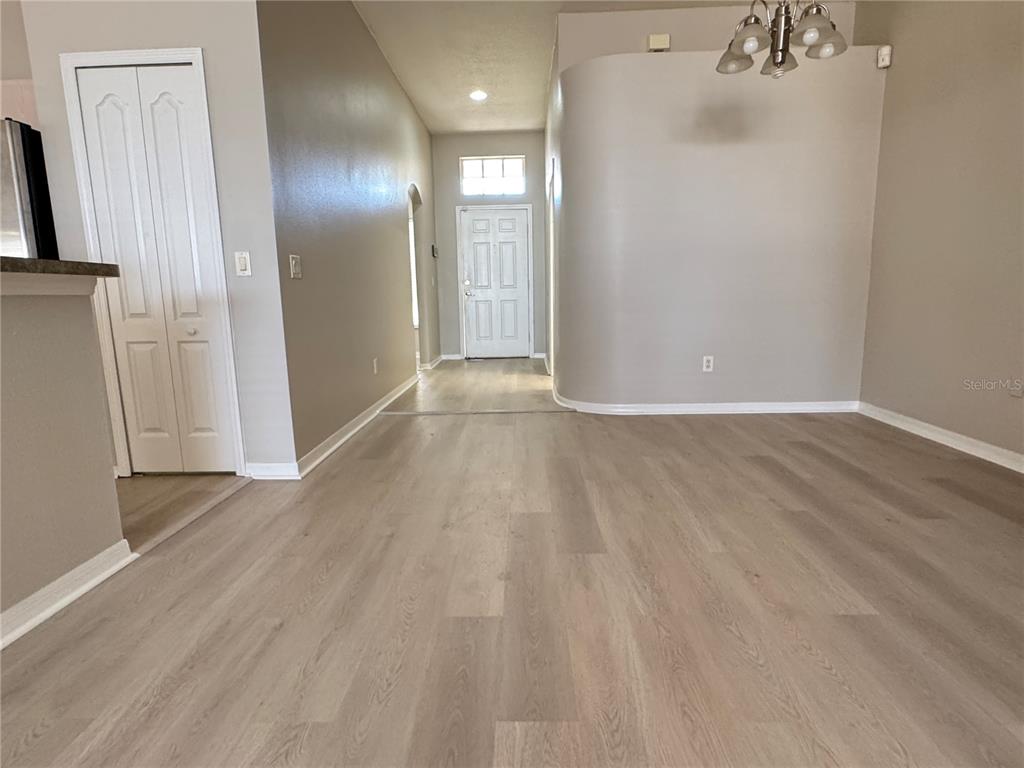 1414 Trail Boss Lane Brandon, FL 33511 - Photo 9 of 37 a view of a livingroom with wooden floor and staircase