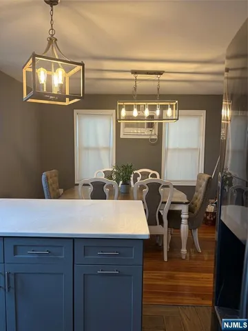 a view of a dining room with furniture and chandelier
