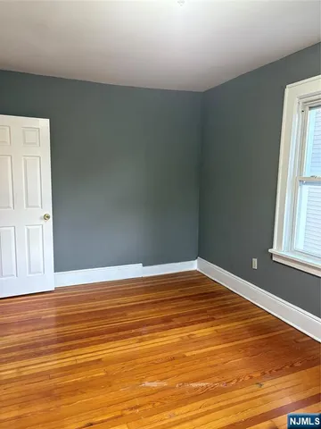 a view of a room with wooden floor and windows
