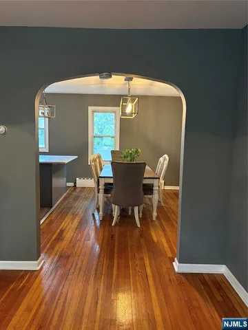 a dining room with furniture and wooden floor