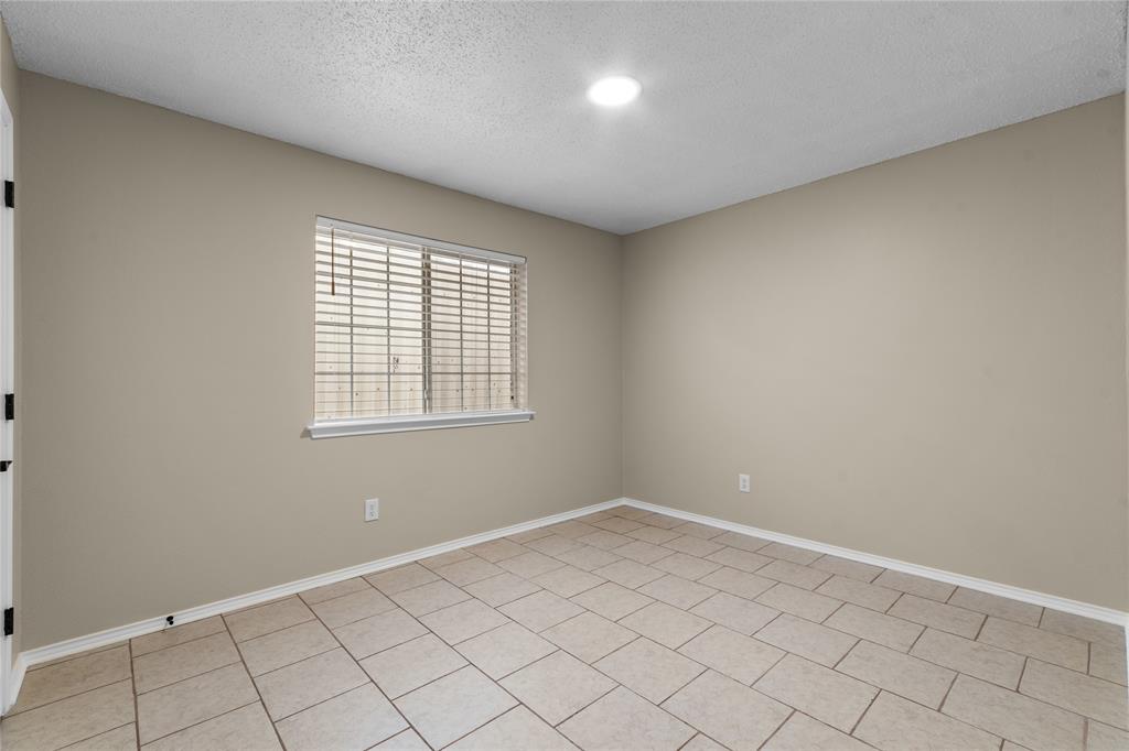 1035 North Ravinia Drive Dallas, TX 75211 - Photo 14 of 20 wooden floor in an empty room with a window