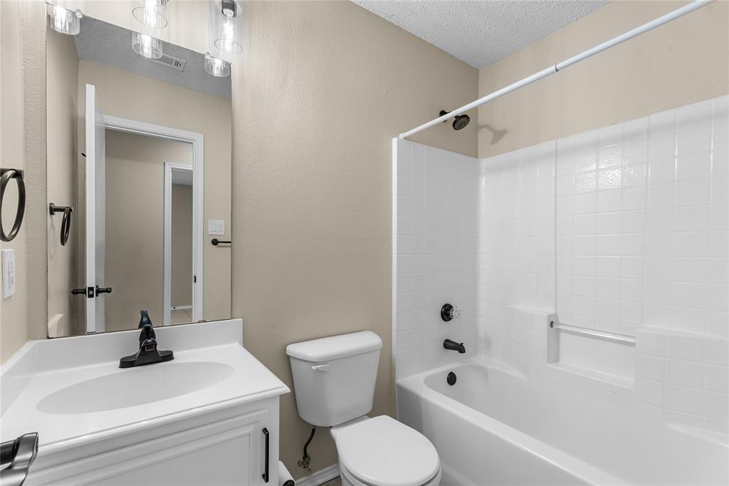 1035 North Ravinia Drive Dallas, TX 75211 - Photo 15 of 20 a bathroom with a sink toilet and shower