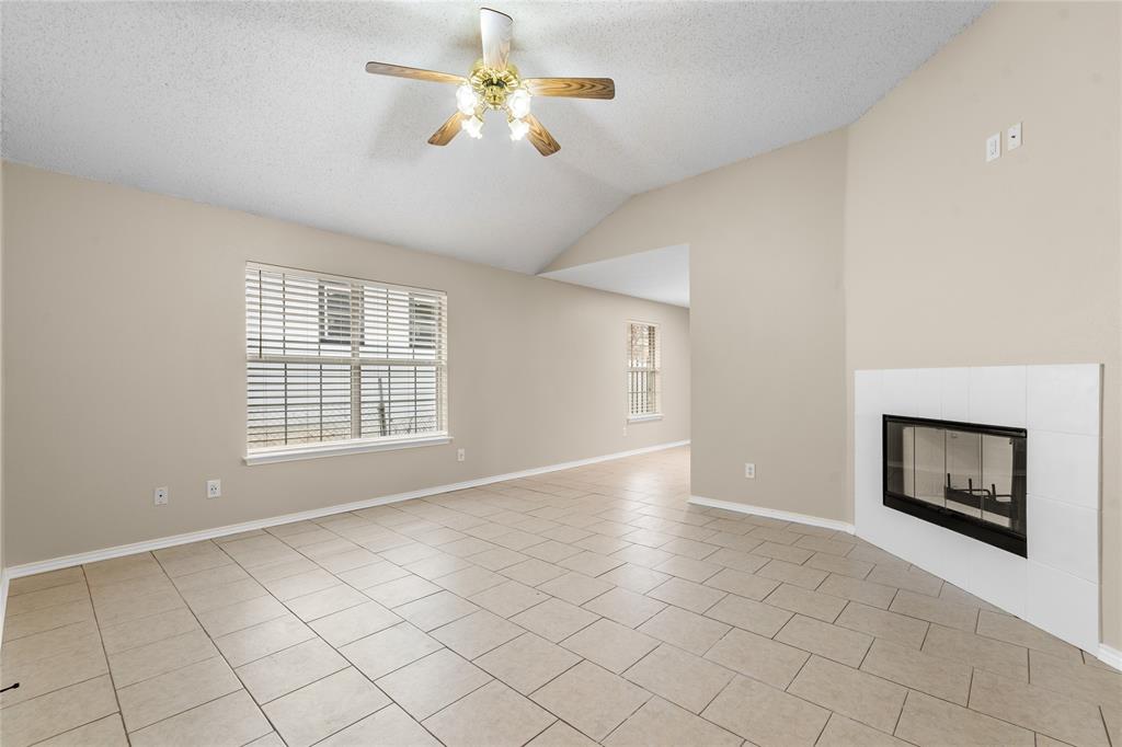 1035 North Ravinia Drive Dallas, TX 75211 - Photo 4 of 20 a view of an empty room with a fireplace and a window