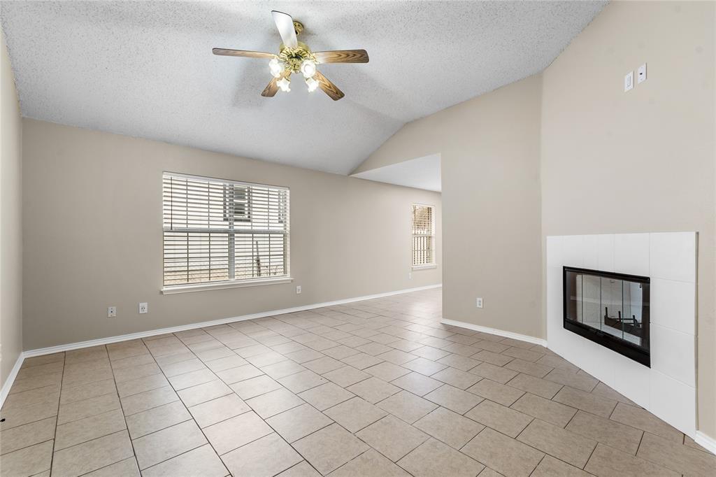 1035 North Ravinia Drive Dallas, TX 75211 - Photo 6 of 20 a view of an empty room with a fireplace and a window