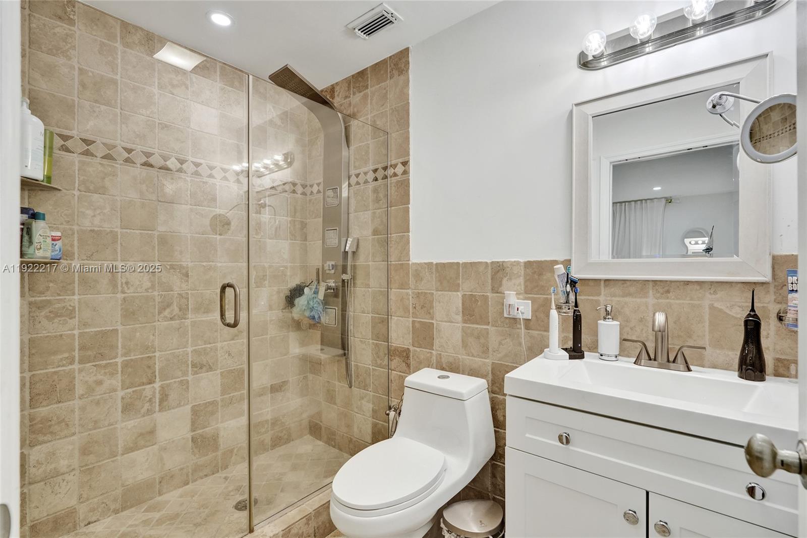 10401 Southwest 53rd Street Miami, FL 33165 - Photo 22 of 50 a bathroom with a sink a toilet and shower