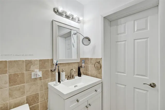 a bathroom with a double vanity sink mirror and