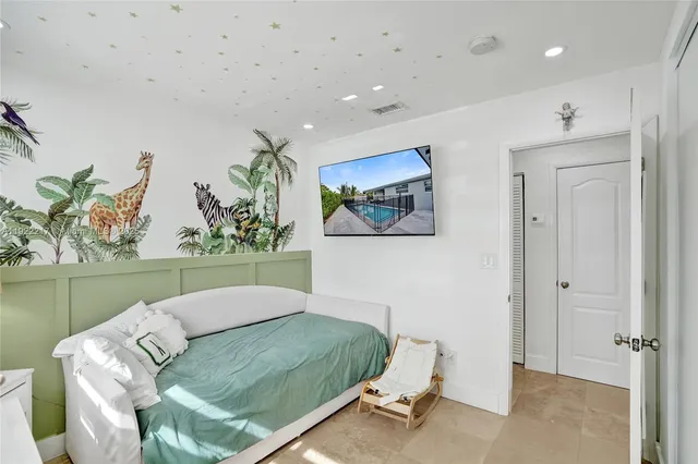 a living room with a bed and a painting on the wall
