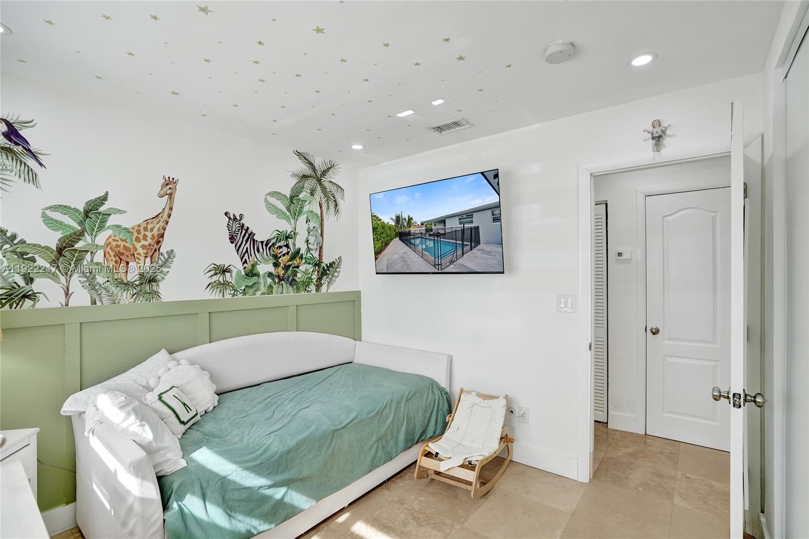 10401 Southwest 53rd Street Miami, FL 33165 - Photo 26 of 50 a living room with a bed and a painting on the wall