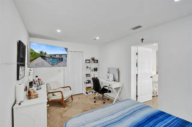 a view of a workspace with furniture and wooden floor