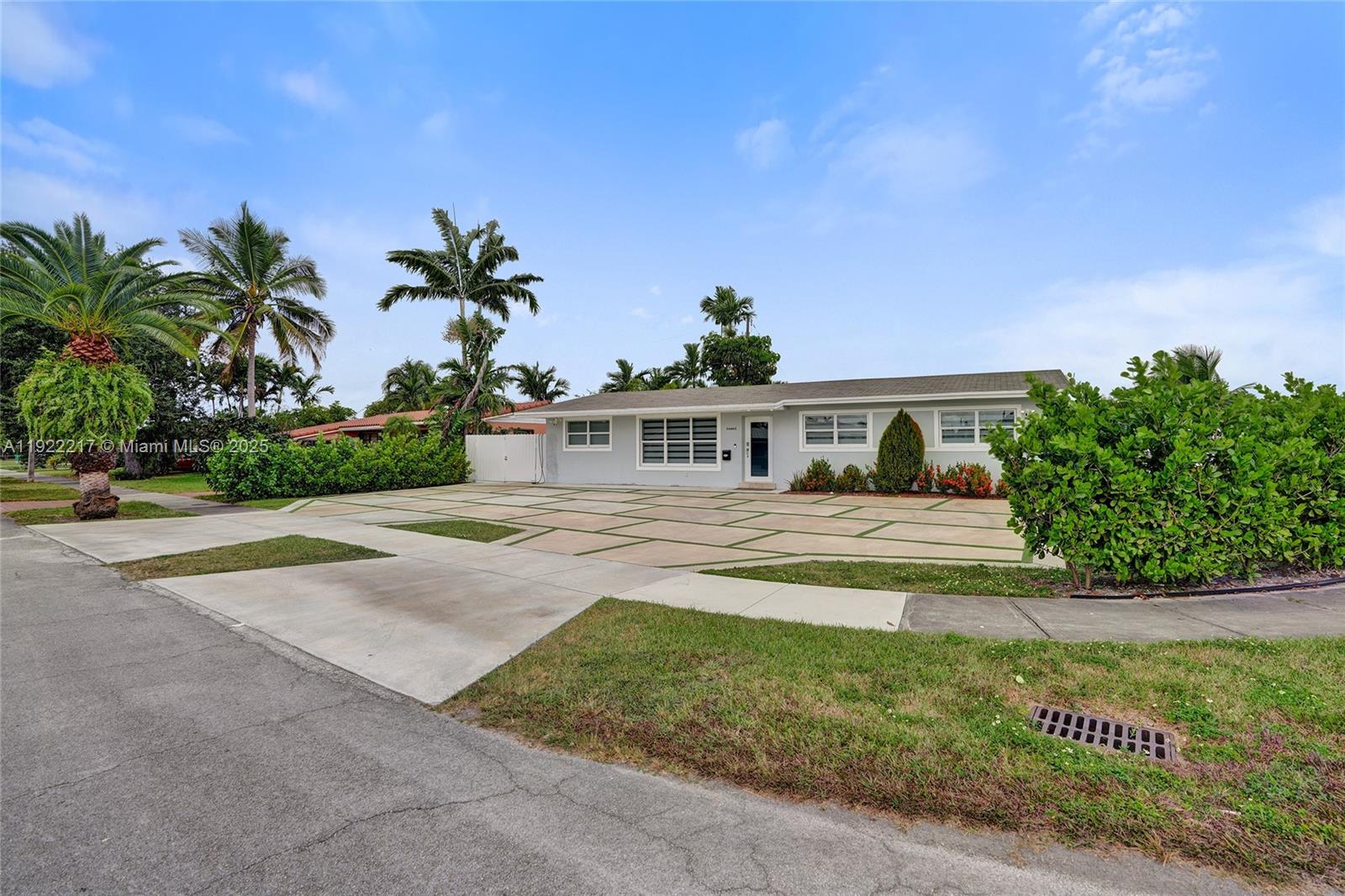 10401 Southwest 53rd Street Miami, FL 33165 - Photo 3 of 50 a front view of a house with a yard and potted plants