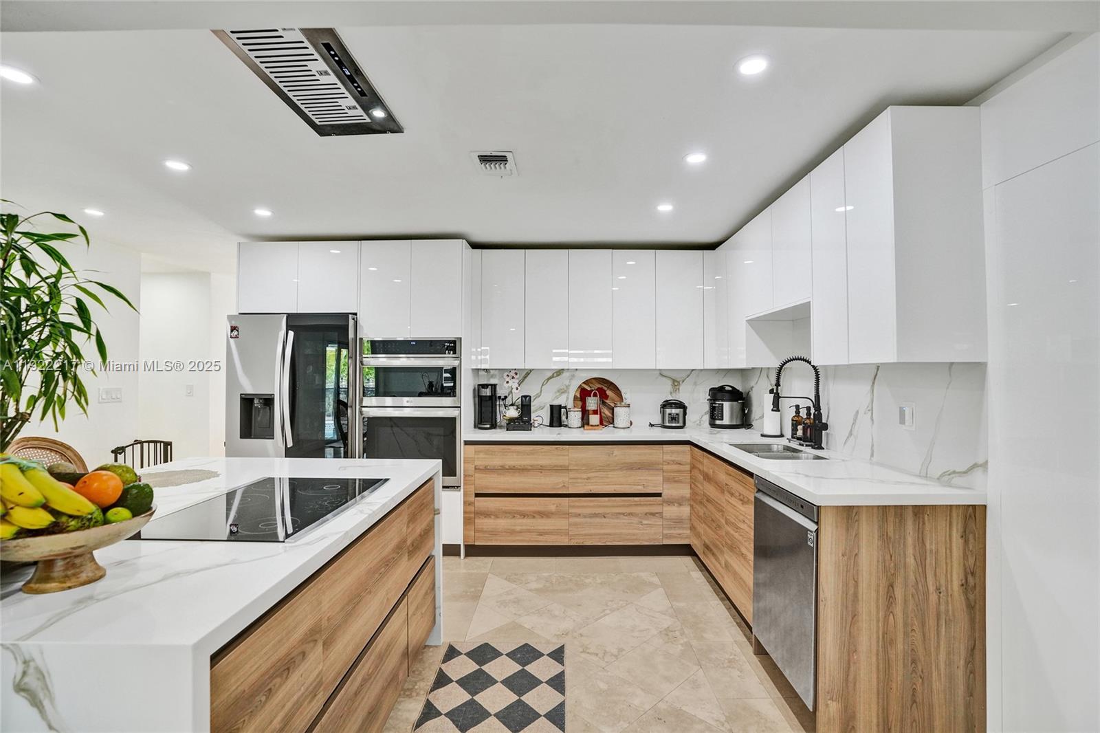 10401 Southwest 53rd Street Miami, FL 33165 - Photo 35 of 50 a kitchen with stainless steel appliances granite countertop a sink a stove and a refrigerator