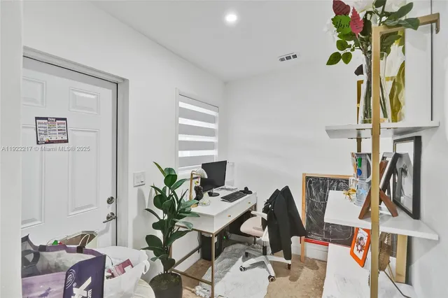 a view of a workspace with furniture and a potted plant