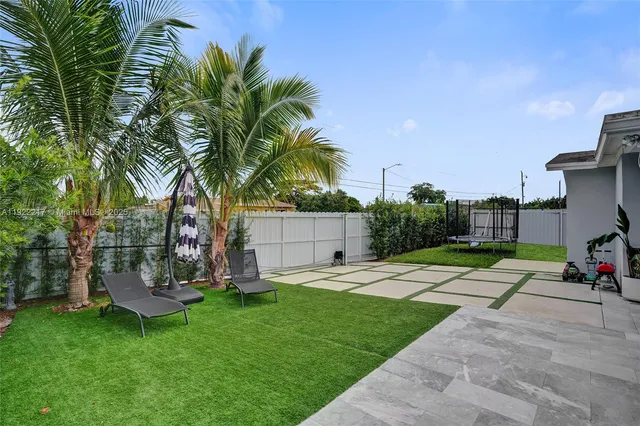 a view of a backyard with a garden and plants
