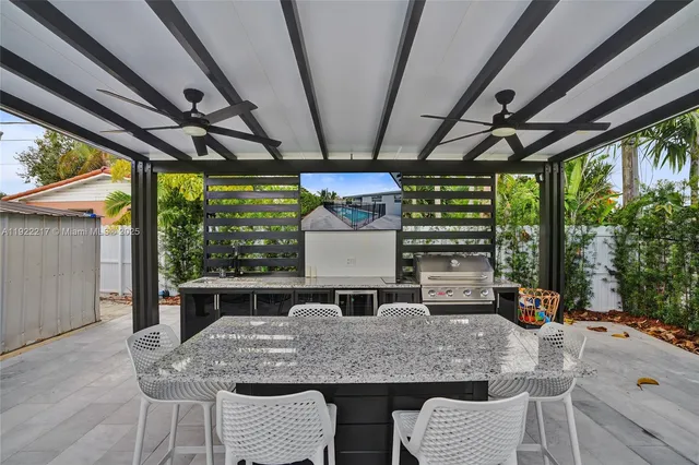 a kitchen with a table chairs and wooden floor