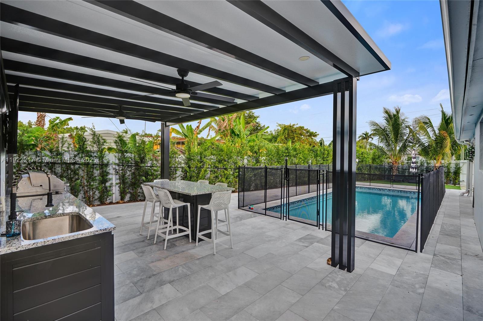 10401 Southwest 53rd Street Miami, FL 33165 - Photo 47 of 50 a view of a patio with a table chairs and a backyard