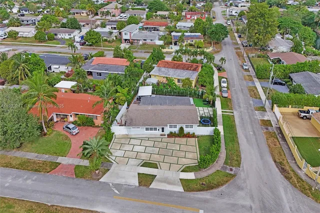 an aerial view of residential houses and outdoor space