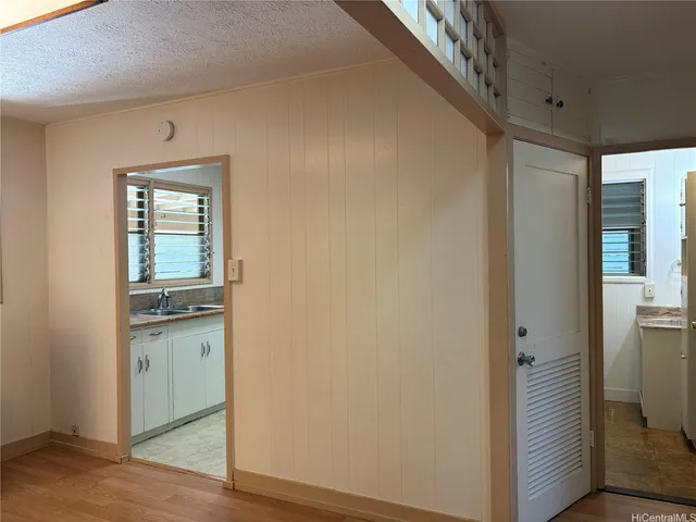 a view of a kitchen from a hallway