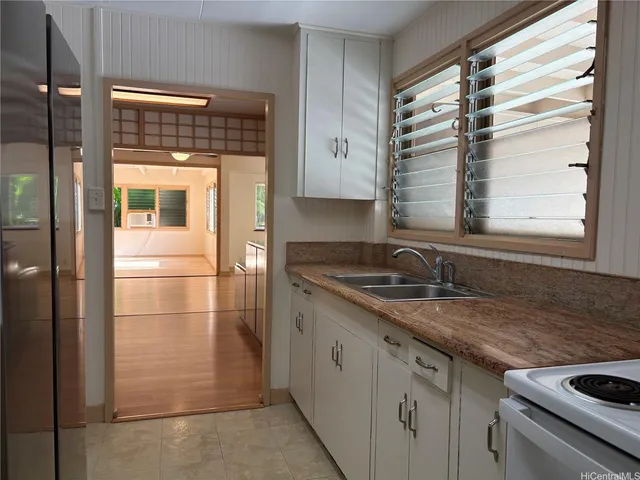 a kitchen with granite countertop a sink and a window