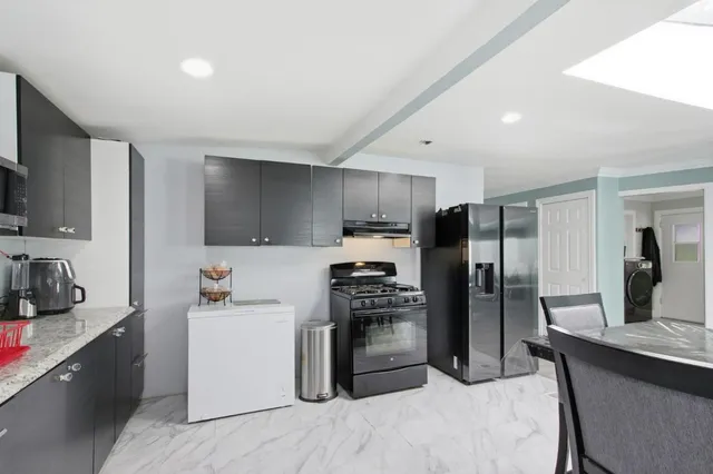 a kitchen with stainless steel appliances a refrigerator stove microwave and sink