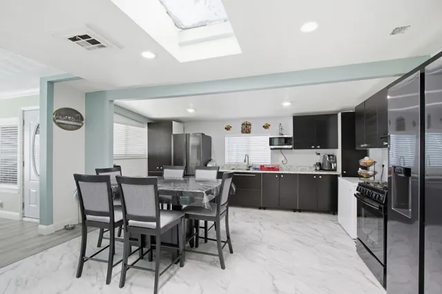 a kitchen with a table and chairs in it