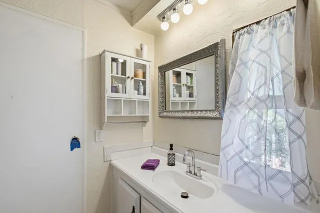 a bathroom with a sink and a mirror