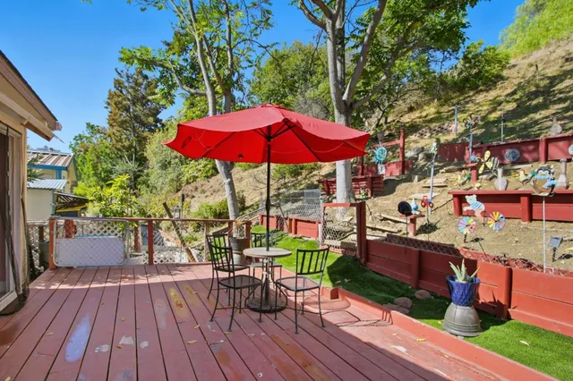 a view of a chairs and table in the backyard