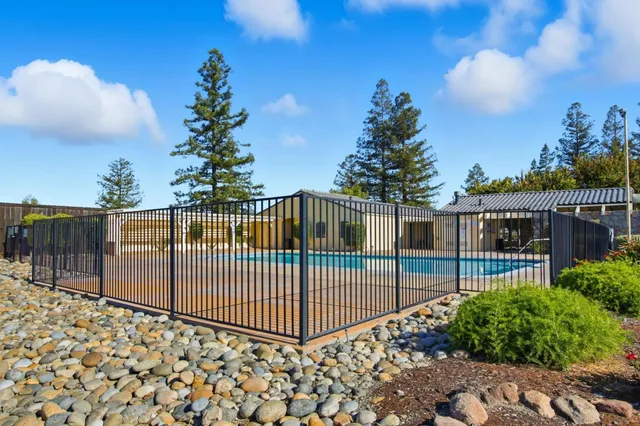 a view of a house with a yard and pathway