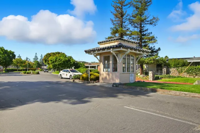 a view of a house with a yard patio and a fountain